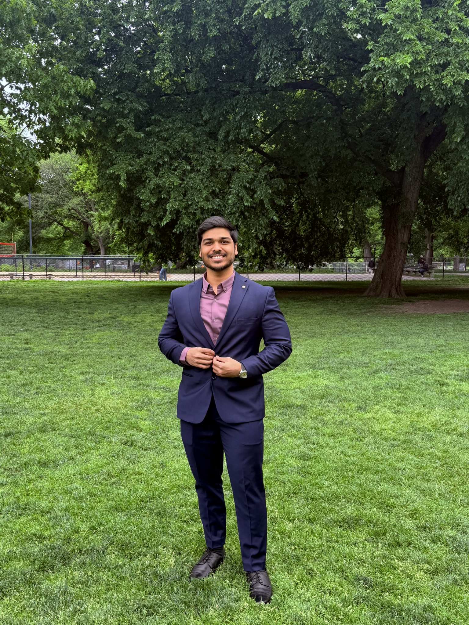 Portrait of Venu Gopal Kadamba in a navy suit, outdoors